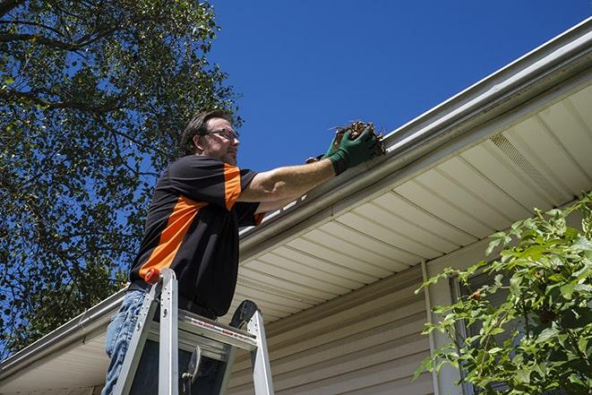 a professional repairing gutters damaged by a storm in Calabasas